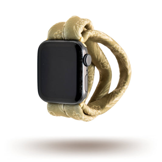 Amber Blossoms Yoga Band® featuring a delicate orange and white floral pattern on a soft fabric background. This breathable, patent-pending design is a stretchy handcrafted watch strap compatible with Apple Watch, Fitbit, and Samsung Galaxy