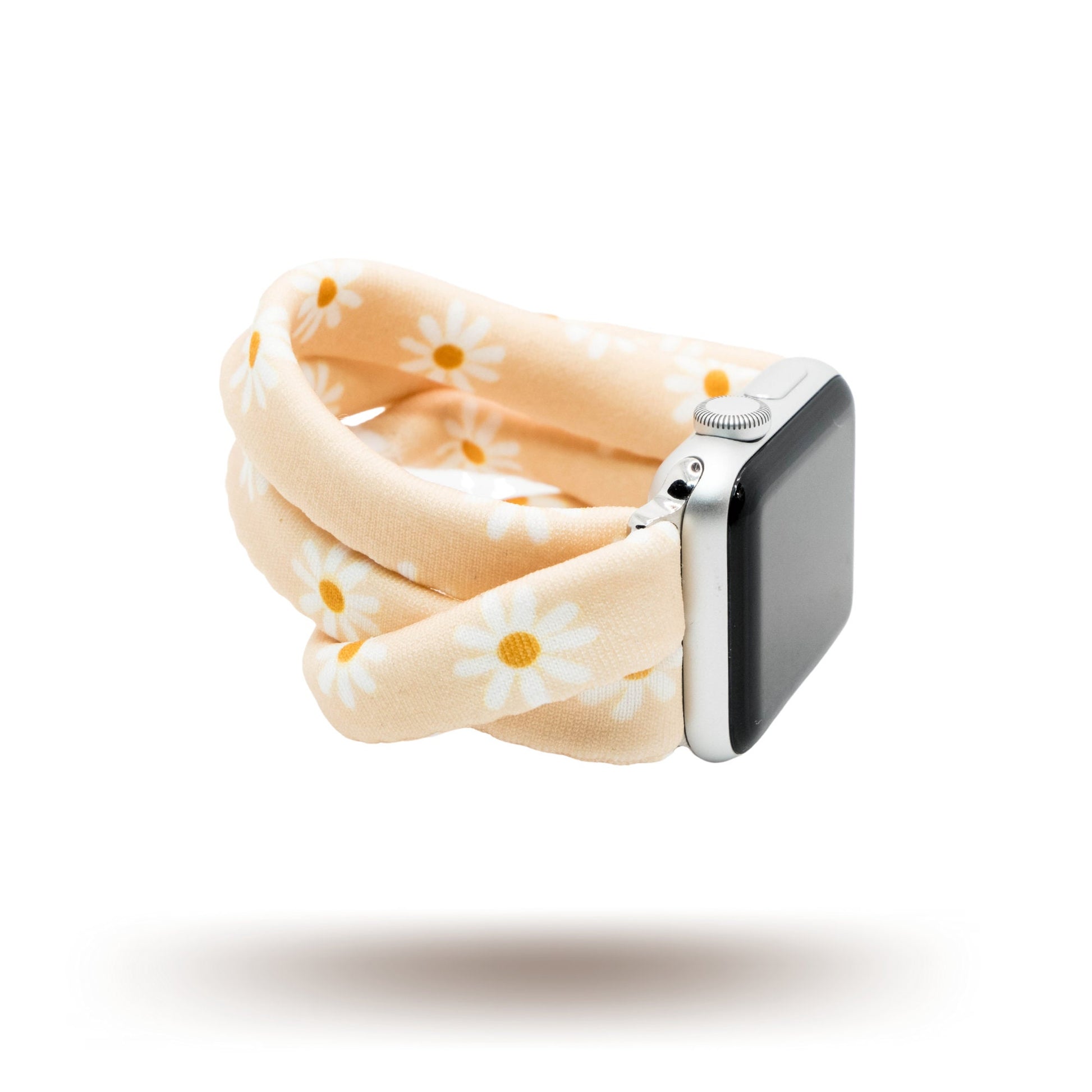 Apricot Daisies Yoga Band® featuring a white and yellow floral print on an apricot fabric background. A stretchy, breathable handcrafted watch strap compatible with Apple Watch, Fitbit, and Samsung Galaxy.