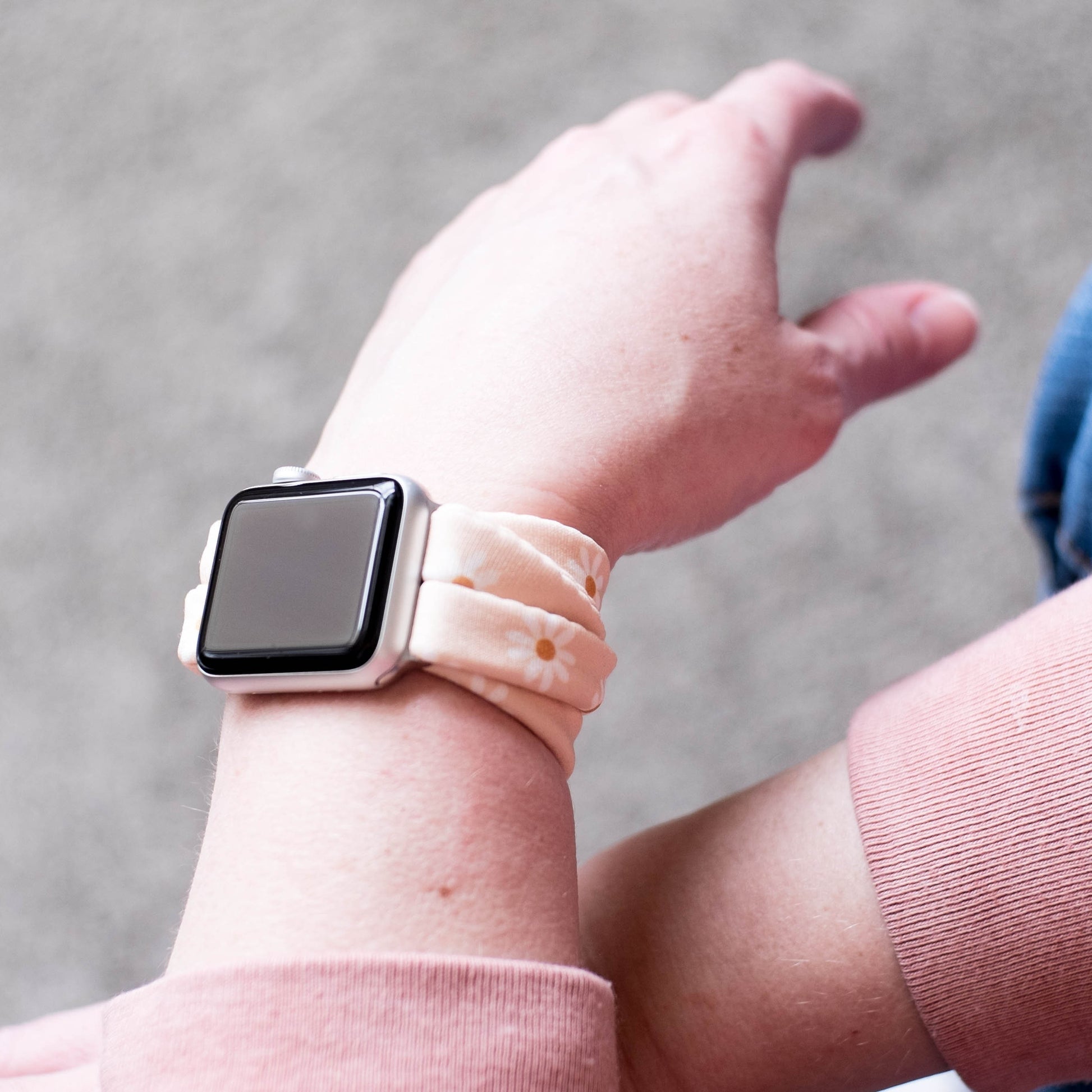 Apricot Daisies Yoga Band® featuring a white and yellow floral print on an apricot fabric background. A stretchy, breathable handcrafted watch strap compatible with Apple Watch, Fitbit, and Samsung Galaxy.