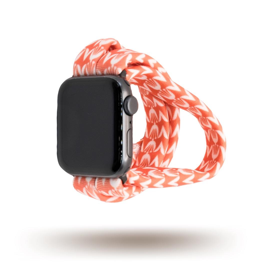 Berry Blooms Yoga Band® featuring a vibrant coral, salmon, and orange-pink floral print on a soft fabric background. A breathable, stretchy handcrafted watch strap compatible with Apple Watch, Fitbit, and Samsung Galaxy.