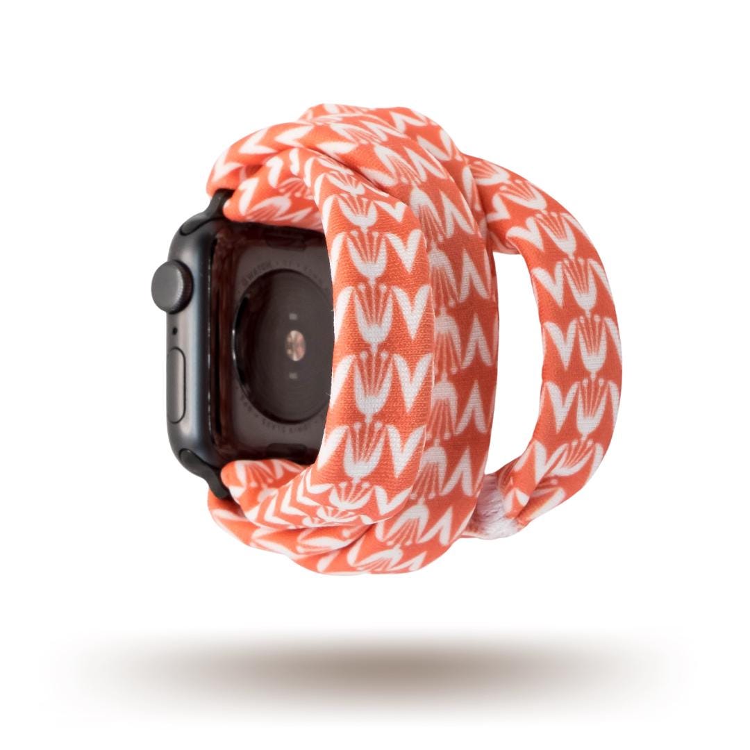 Berry Blooms Yoga Band® featuring a vibrant coral, salmon, and orange-pink floral print on a soft fabric background. A breathable, stretchy handcrafted watch strap compatible with Apple Watch, Fitbit, and Samsung Galaxy.
