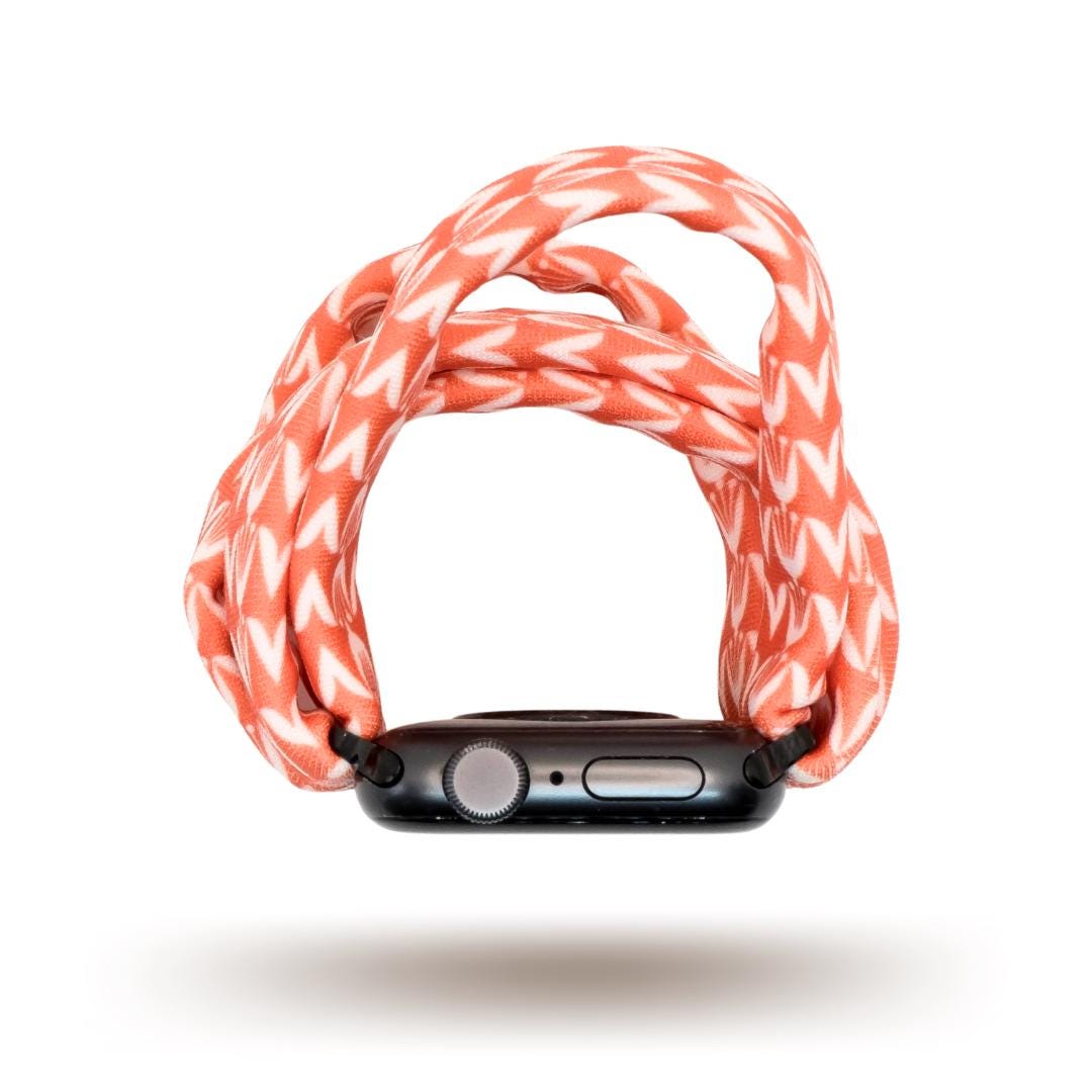 Berry Blooms Yoga Band® featuring a vibrant coral, salmon, and orange-pink floral print on a soft fabric background. A breathable, stretchy handcrafted watch strap compatible with Apple Watch, Fitbit, and Samsung Galaxy.