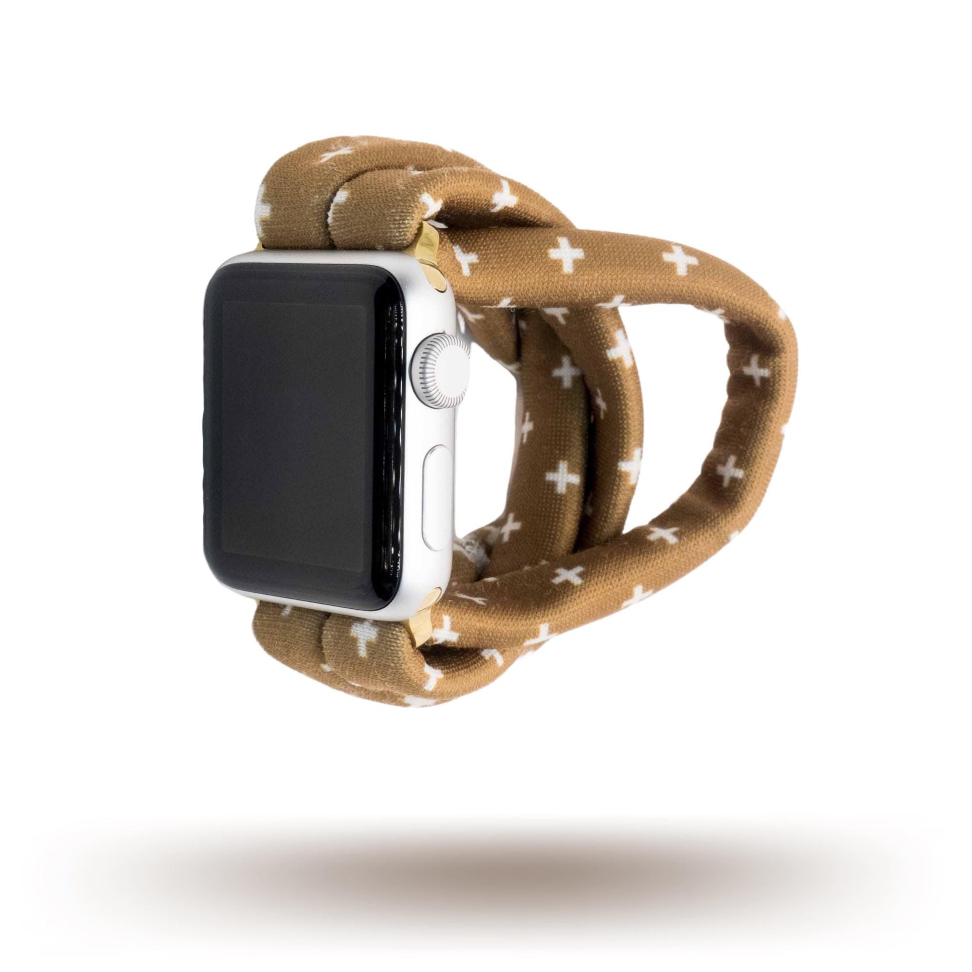 Chestnut Plus Yoga Band® featuring a white plus pattern on a warm brown fabric background. A breathable, stretchy watch strap with a patent-pending design compatible with Apple Watch, Fitbit, and Samsung Galaxy models.