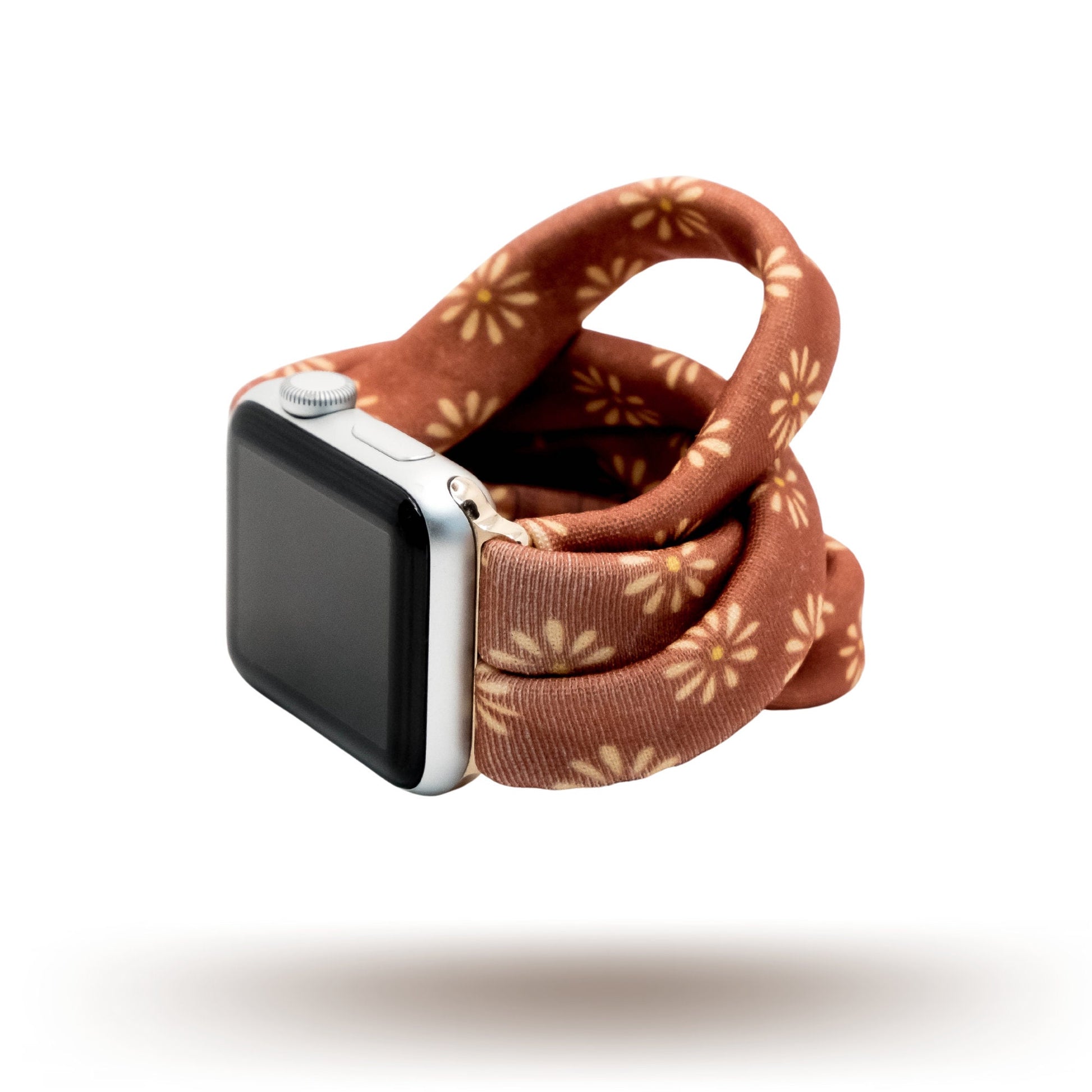 Copper Bloom Yoga Band® featuring a yellow and orange floral print on a rust-copper fabric. A breathable, stretchy watch strap with a patent-pending design compatible with Apple Watch, Fitbit, and Samsung Galaxy models.