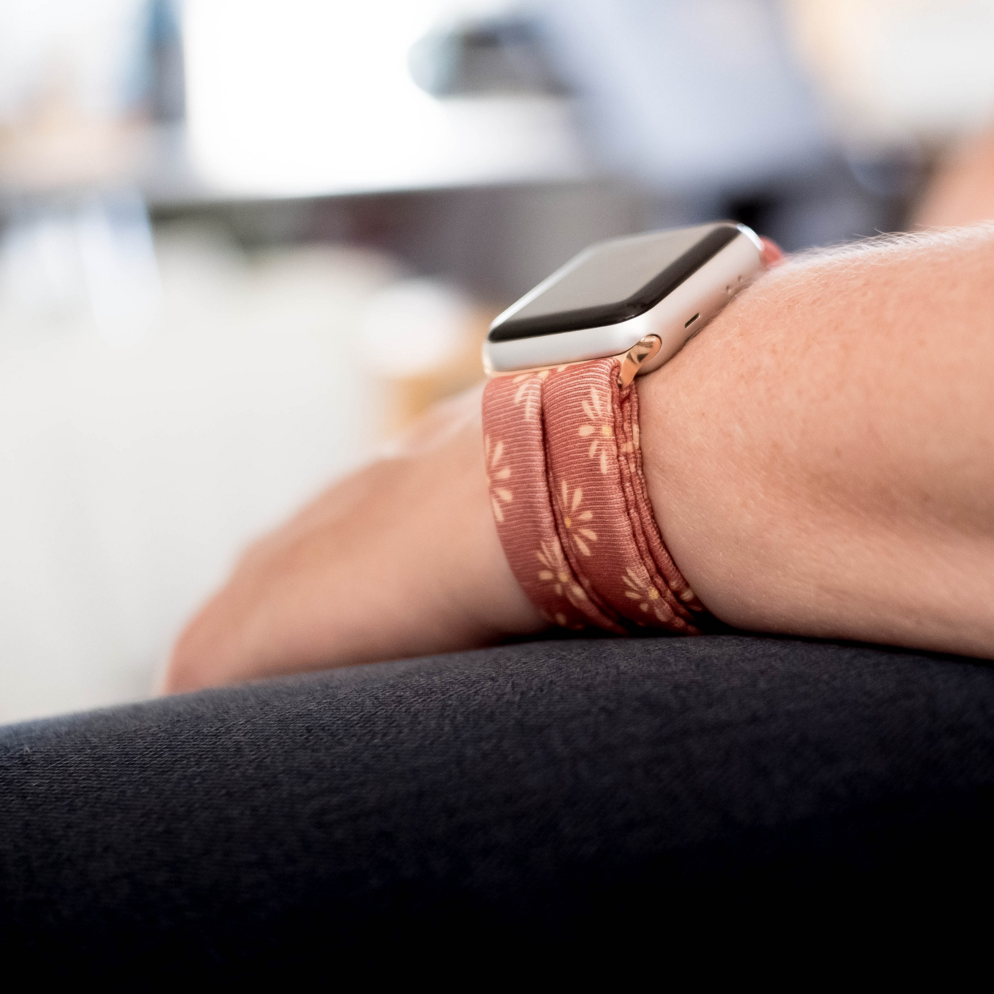 Copper Bloom Yoga Band® featuring a yellow and orange floral print on a rust-copper fabric. A breathable, stretchy watch strap with a patent-pending design compatible with Apple Watch, Fitbit, and Samsung Galaxy models.