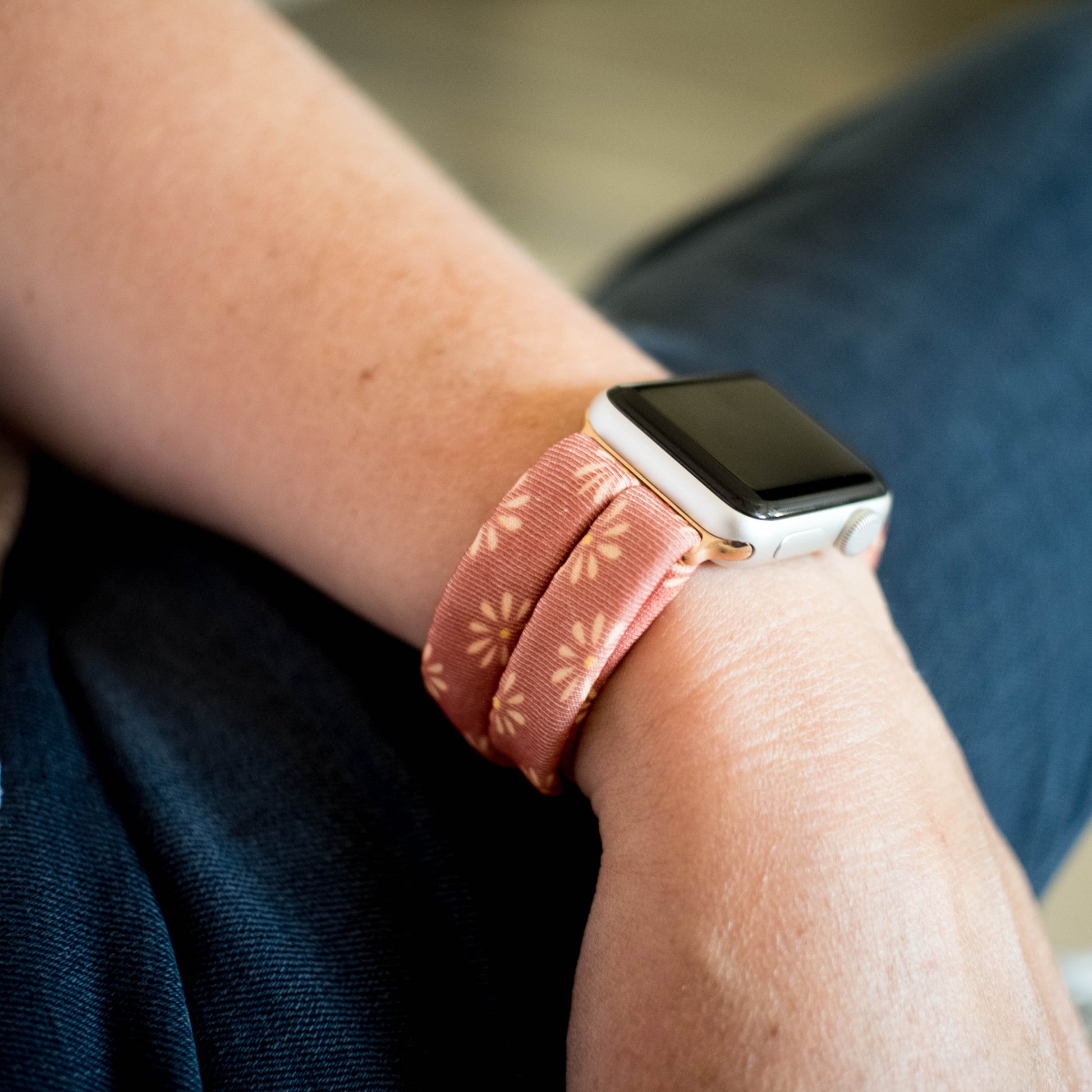 Copper Bloom Yoga Band® featuring a yellow and orange floral print on a rust-copper fabric. A breathable, stretchy watch strap with a patent-pending design compatible with Apple Watch, Fitbit, and Samsung Galaxy models.
