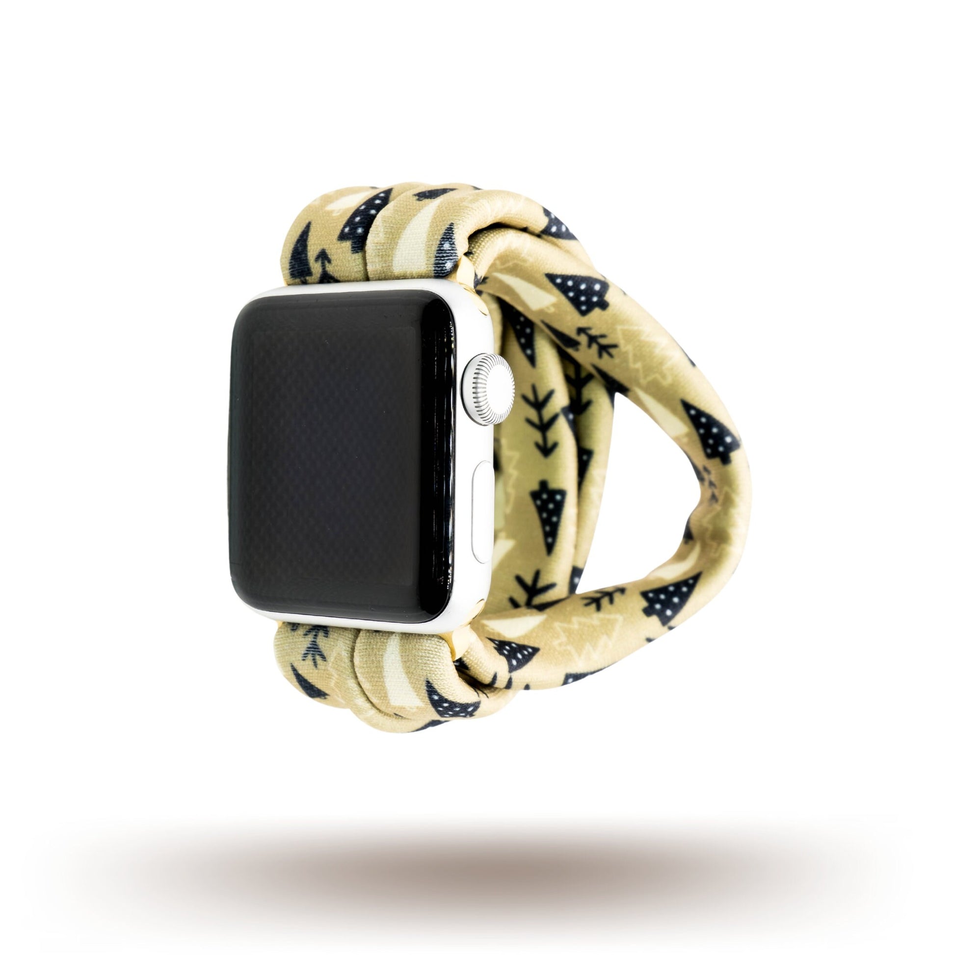 Earthy Pines Yoga Band® featuring a brown pine tree print on a tan fabric background. A breathable, stretchy watch strap with a patent-pending design compatible with Apple Watch, Fitbit, and Samsung Galaxy models.