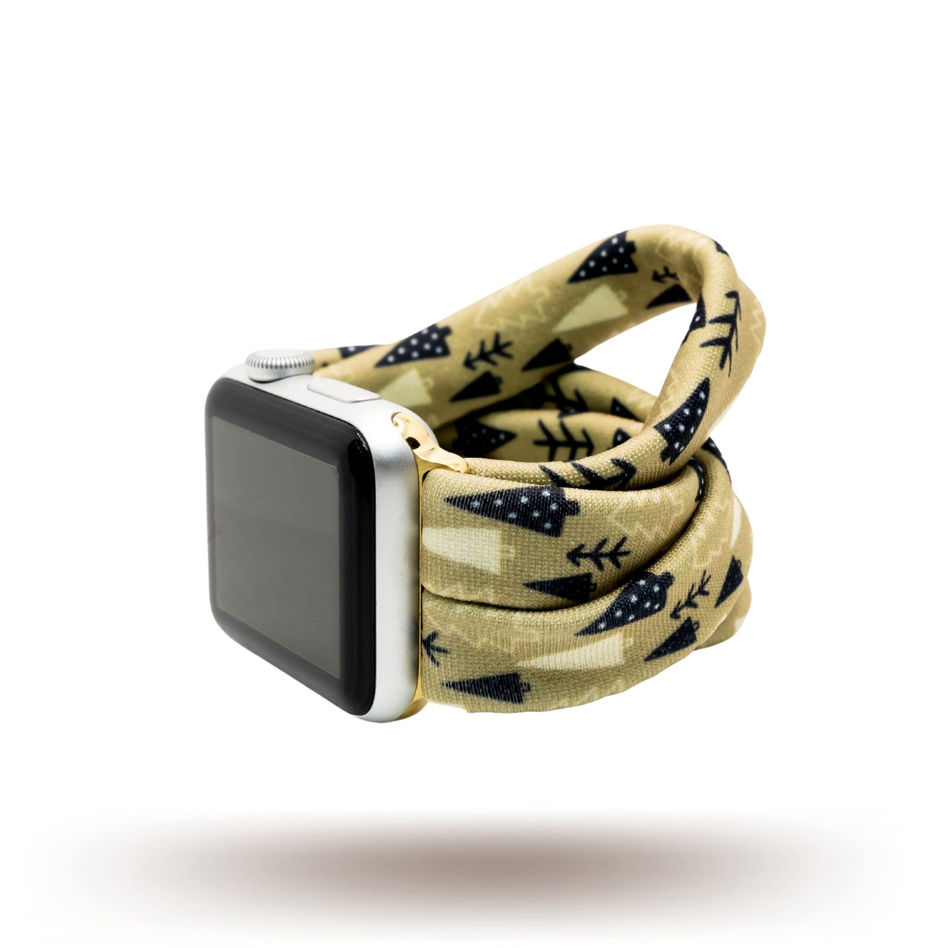 Earthy Pines Yoga Band® featuring a brown pine tree print on a tan fabric background. A breathable, stretchy watch strap with a patent-pending design compatible with Apple Watch, Fitbit, and Samsung Galaxy models.