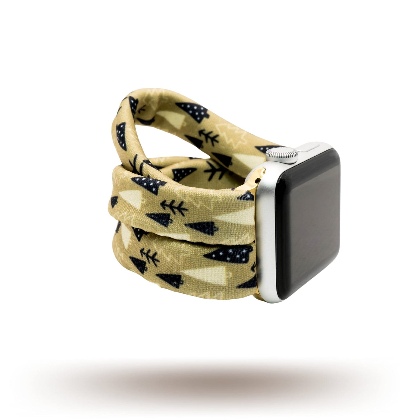 Earthy Pines Yoga Band® featuring a brown pine tree print on a tan fabric background. A breathable, stretchy watch strap with a patent-pending design compatible with Apple Watch, Fitbit, and Samsung Galaxy models.