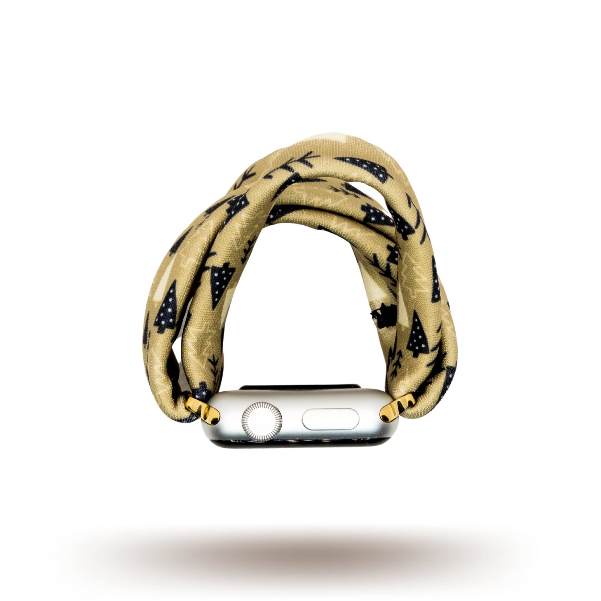 Earthy Pines Yoga Band® featuring a brown pine tree print on a tan fabric background. A breathable, stretchy watch strap with a patent-pending design compatible with Apple Watch, Fitbit, and Samsung Galaxy models.