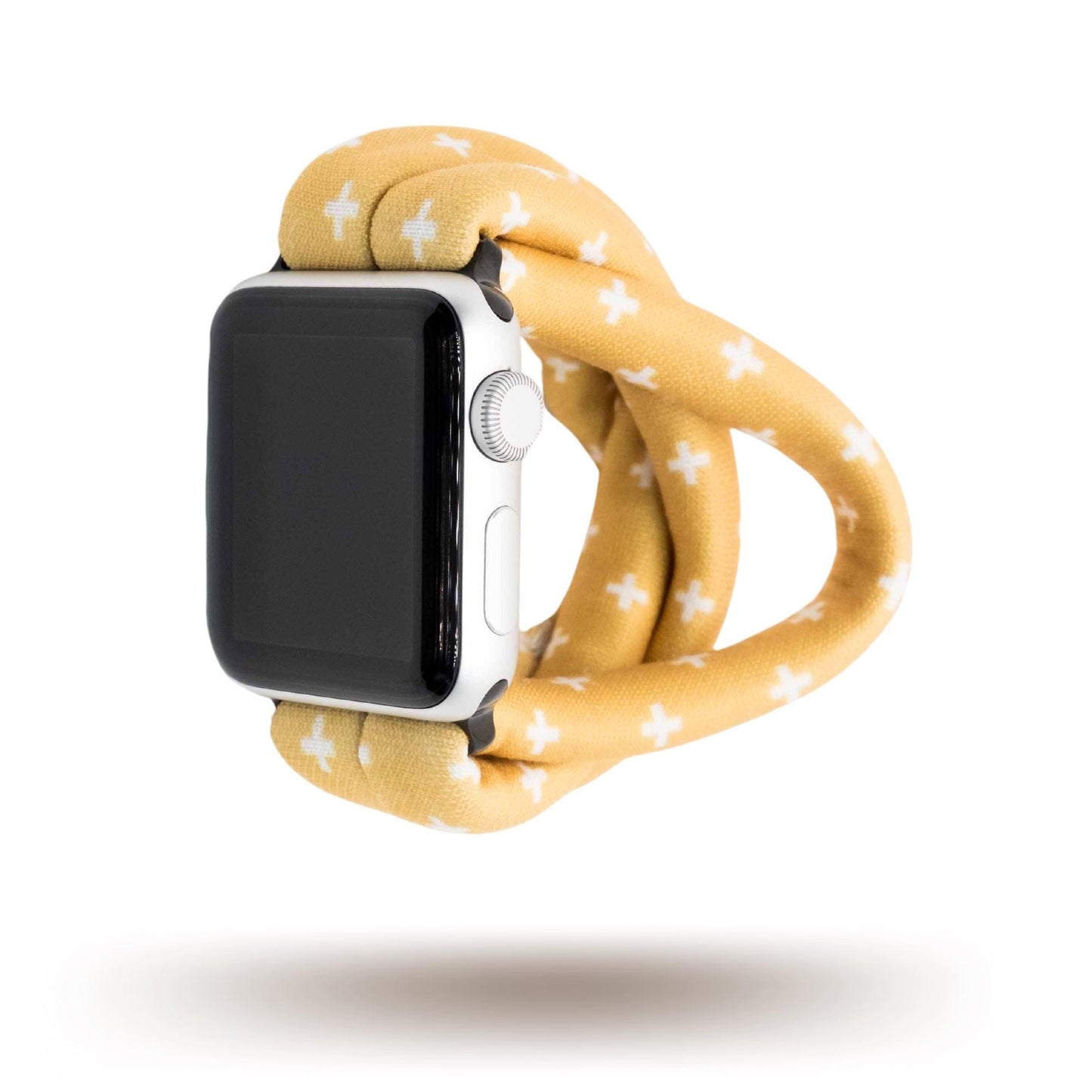 Golden Plus Yoga Band® featuring a white plus sign print on a golden-tan fabric background. A breathable, stretchy watch strap with a patent-pending design compatible with Apple Watch, Fitbit, and Samsung Galaxy models.
