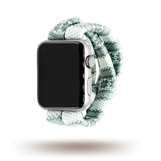 Green Nordic Sweater Yoga Band® featuring a green and white alpine snowflake print. A breathable, stretchy watch strap with a patent-pending design compatible with Apple Watch, Fitbit, and Samsung Galaxy models.
