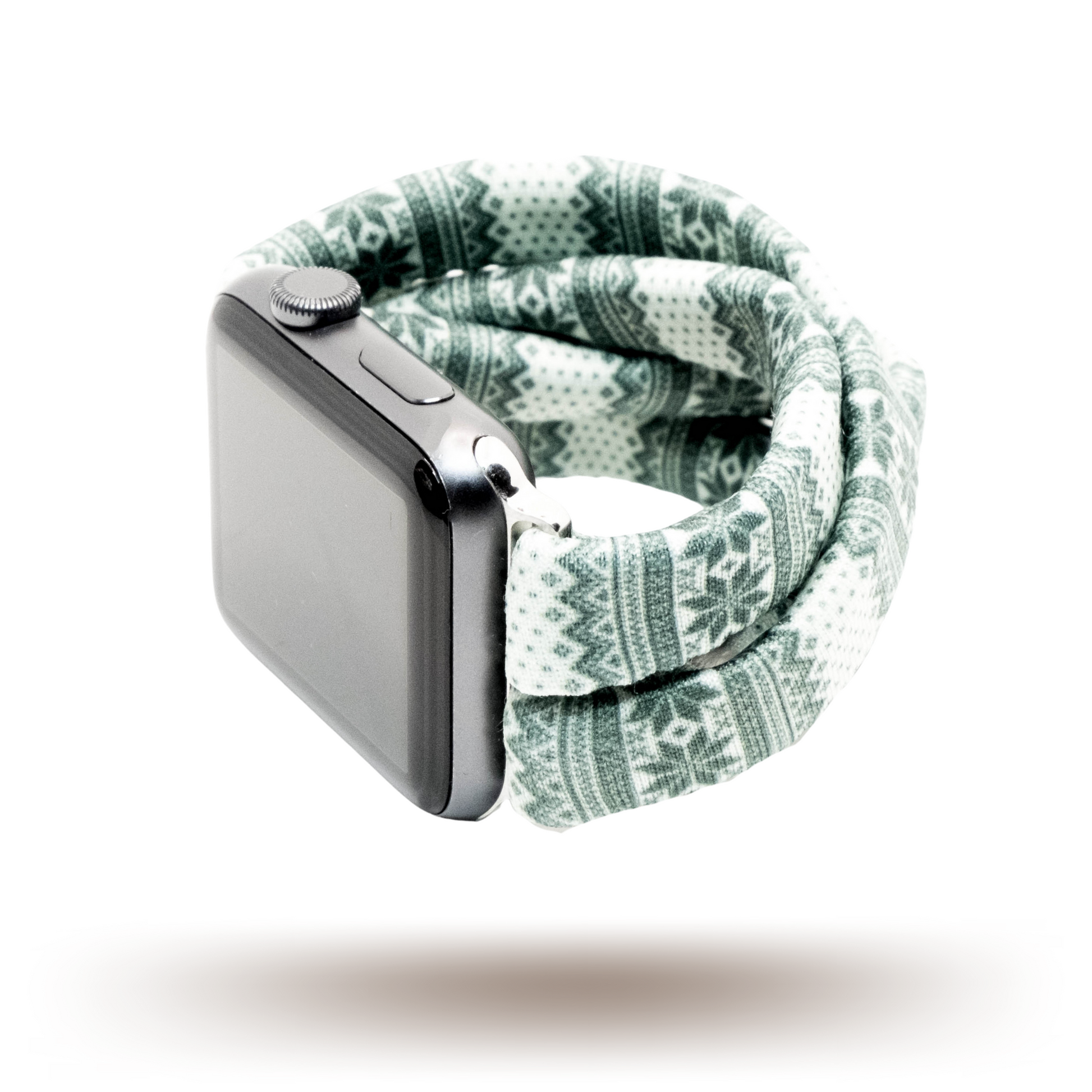 Green Nordic Sweater Yoga Band® featuring a green and white alpine snowflake print. A breathable, stretchy watch strap with a patent-pending design compatible with Apple Watch, Fitbit, and Samsung Galaxy models.