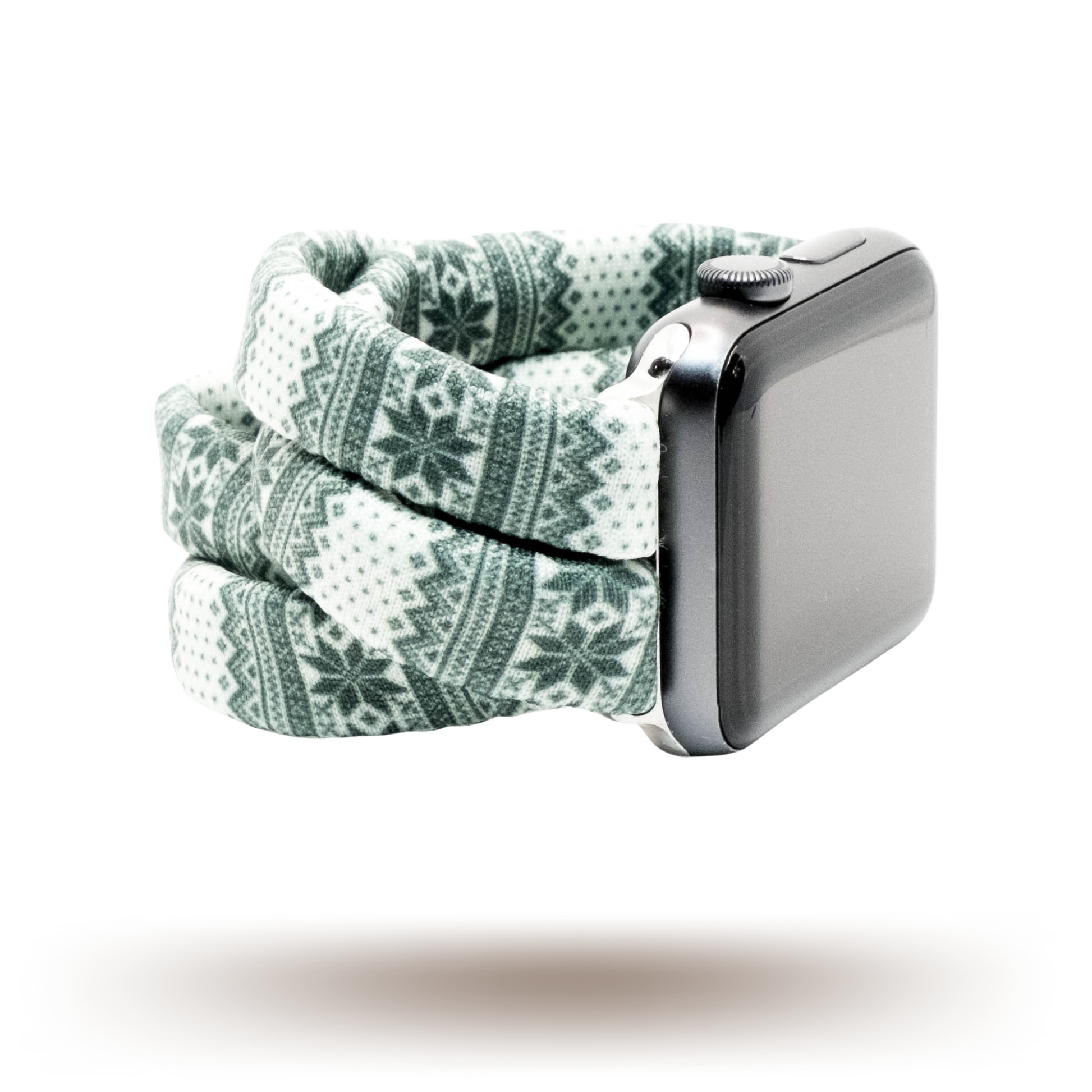 Green Nordic Sweater Yoga Band® featuring a green and white alpine snowflake print. A breathable, stretchy watch strap with a patent-pending design compatible with Apple Watch, Fitbit, and Samsung Galaxy models.