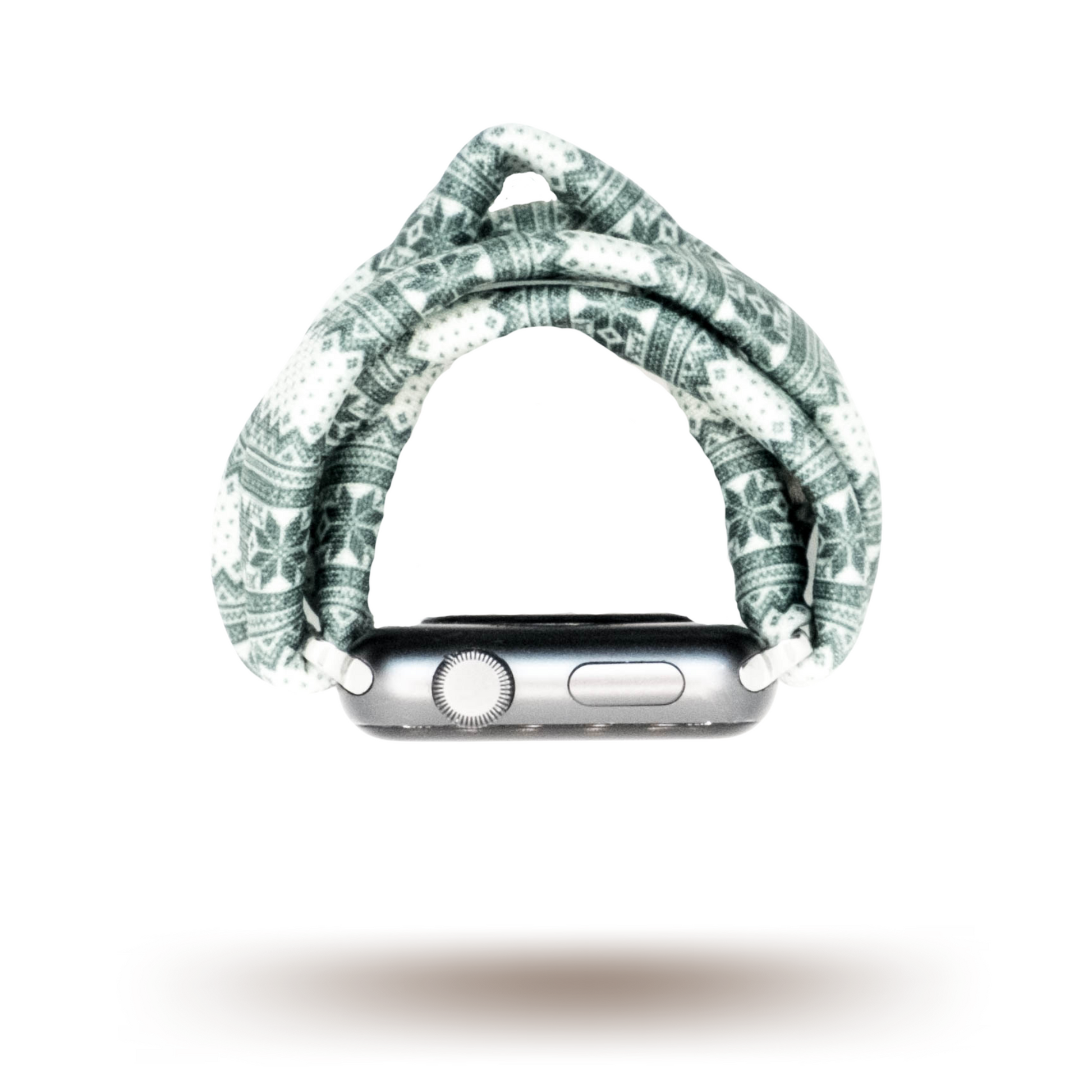 Green Nordic Sweater Yoga Band® featuring a green and white alpine snowflake print. A breathable, stretchy watch strap with a patent-pending design compatible with Apple Watch, Fitbit, and Samsung Galaxy models.