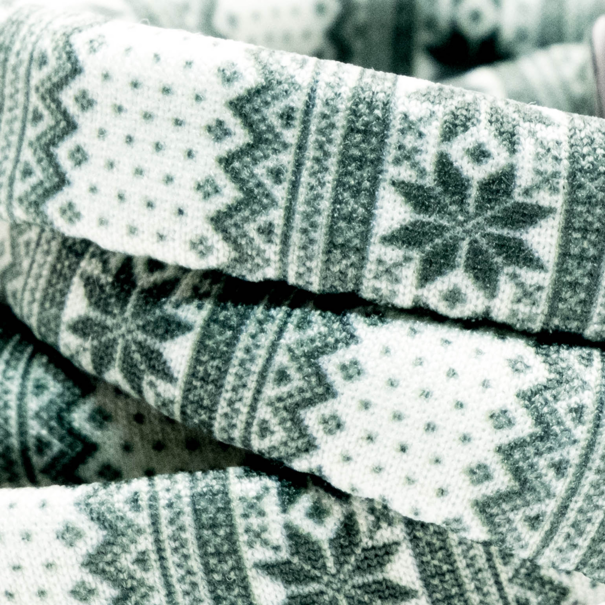 Green Nordic Sweater Yoga Band® featuring a green and white alpine snowflake print. A breathable, stretchy watch strap with a patent-pending design compatible with Apple Watch, Fitbit, and Samsung Galaxy models.