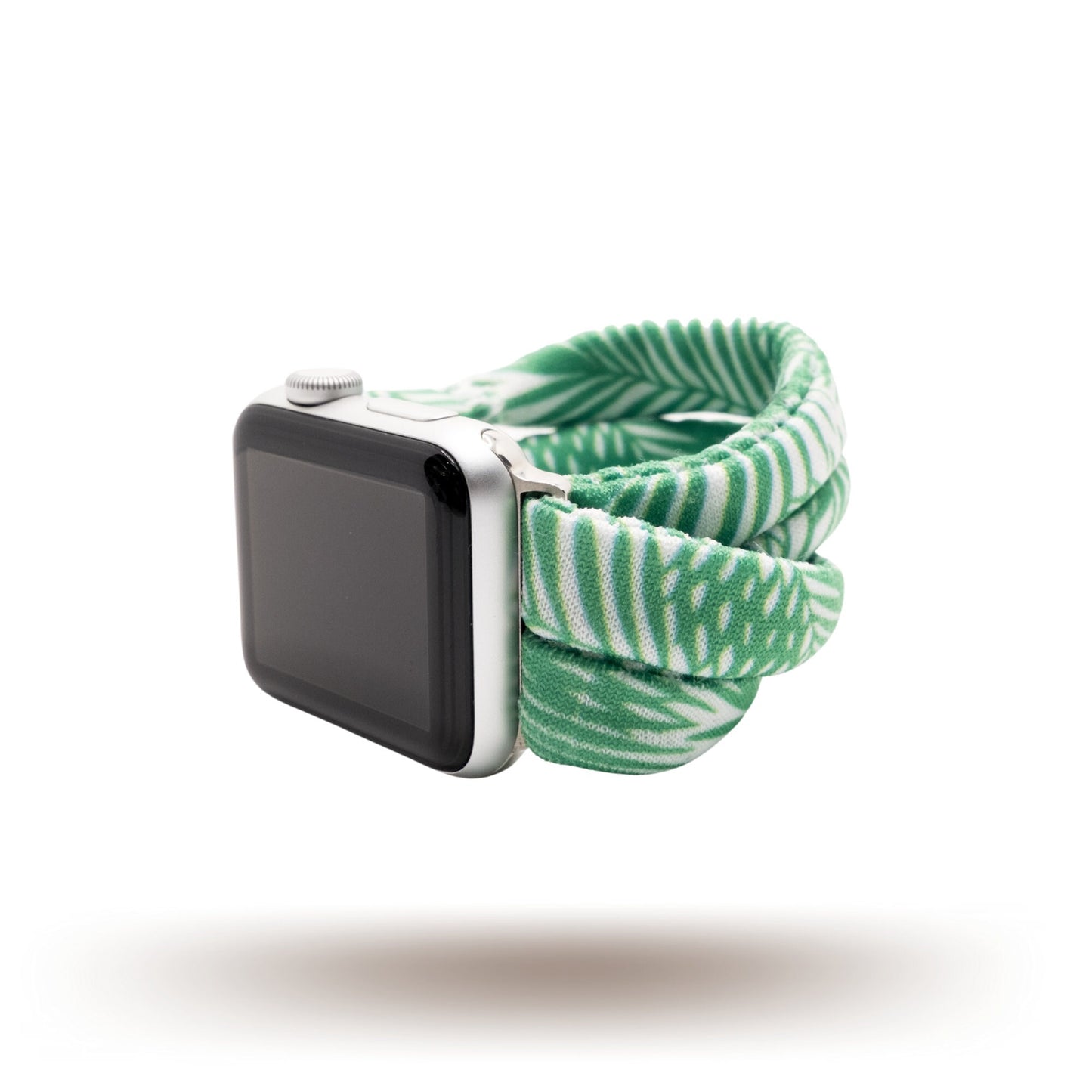 Green Palms Yoga Band® featuring a green and white tropical palm frond print. A breathable, stretchy fabric watch strap with a patent-pending design compatible with Apple Watch, Fitbit, and Samsung Galaxy models.