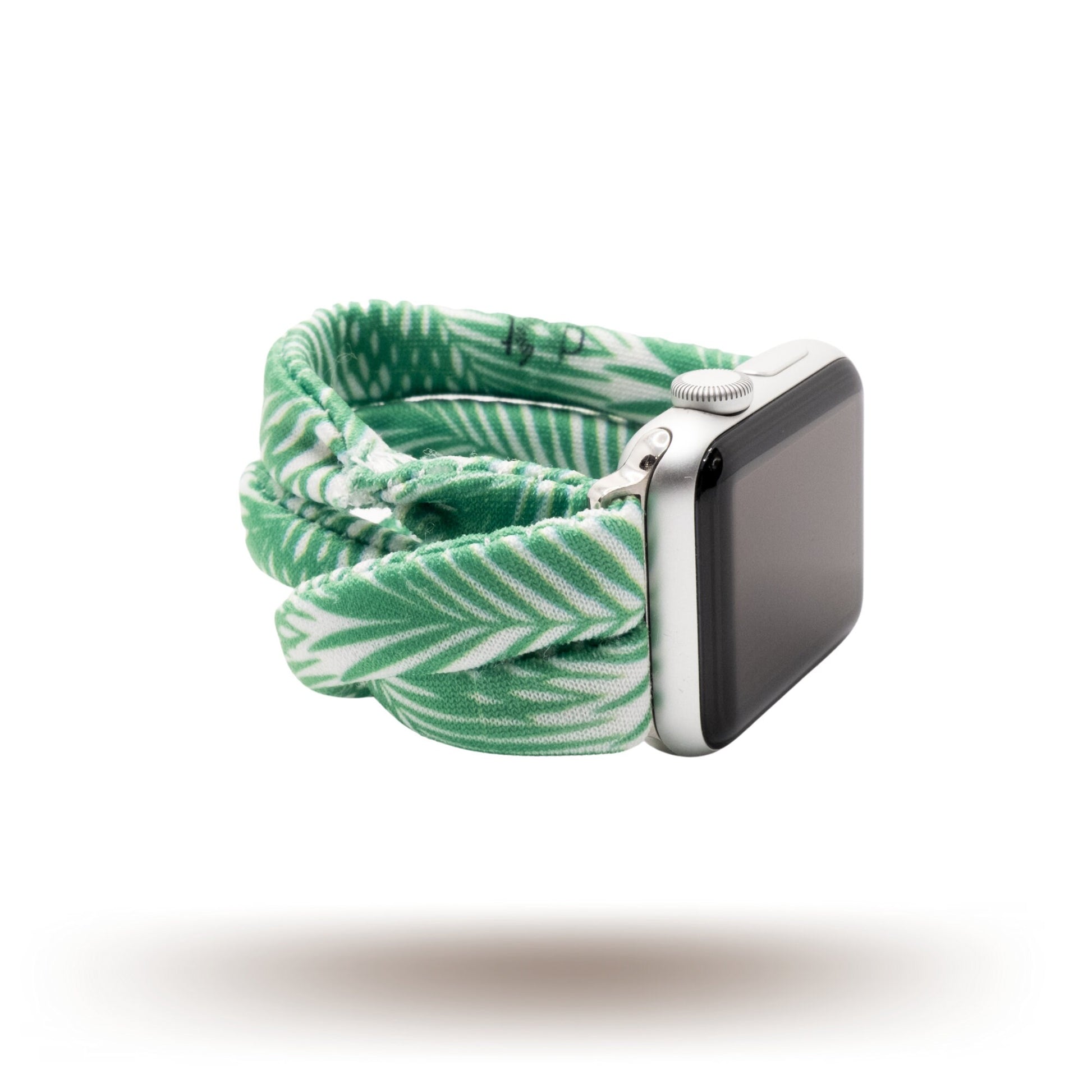 Green Palms Yoga Band® featuring a green and white tropical palm frond print. A breathable, stretchy fabric watch strap with a patent-pending design compatible with Apple Watch, Fitbit, and Samsung Galaxy models.