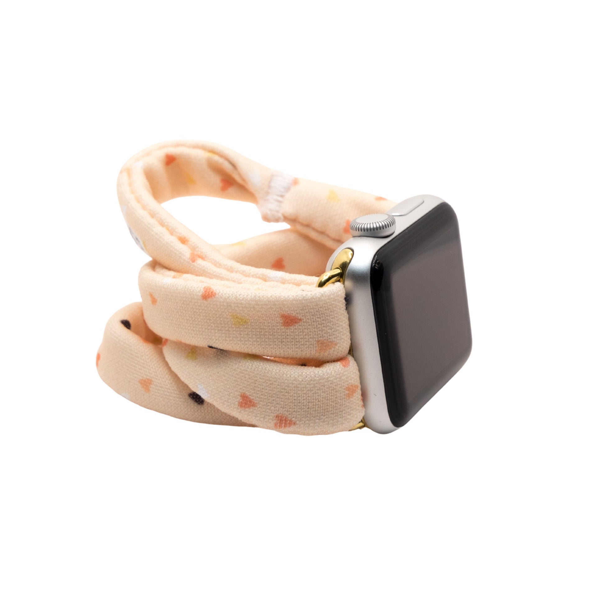 Heartbeat Yoga Band® featuring a tiny heart print in peach, cream, and pink tones. A breathable, stretchy fabric watch strap with a patent-pending design compatible with Apple Watch, Fitbit, and Samsung Galaxy models.