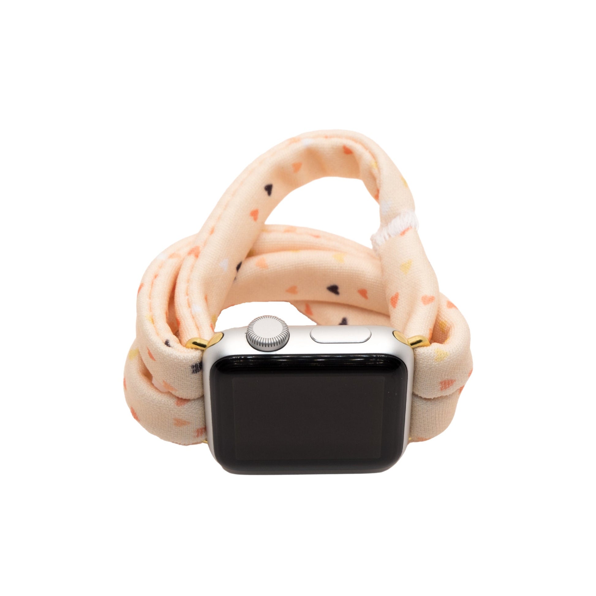 Heartbeat Yoga Band® featuring a tiny heart print in peach, cream, and pink tones. A breathable, stretchy fabric watch strap with a patent-pending design compatible with Apple Watch, Fitbit, and Samsung Galaxy models.