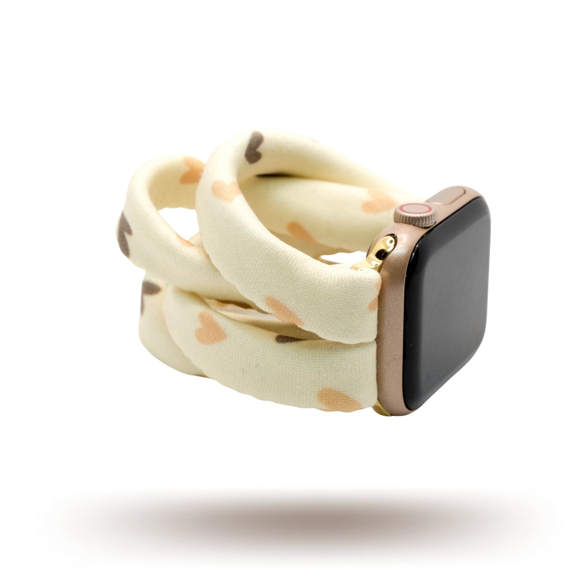 Hearts and Cream Yoga Band® featuring a tan and brown heart print on a cream fabric background. A breathable, stretchy watch strap with a patent-pending design compatible with Apple Watch, Fitbit, and Samsung Galaxy models.