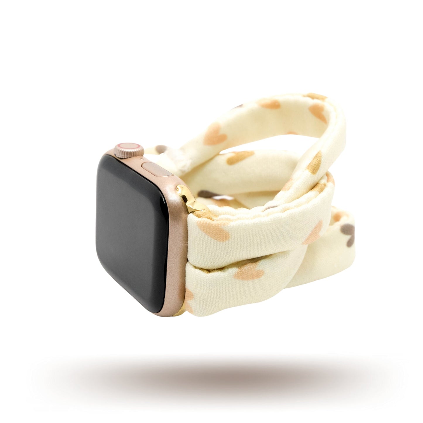 Hearts and Cream Yoga Band® featuring a tan and brown heart print on a cream fabric background. A breathable, stretchy watch strap with a patent-pending design compatible with Apple Watch, Fitbit, and Samsung Galaxy models.